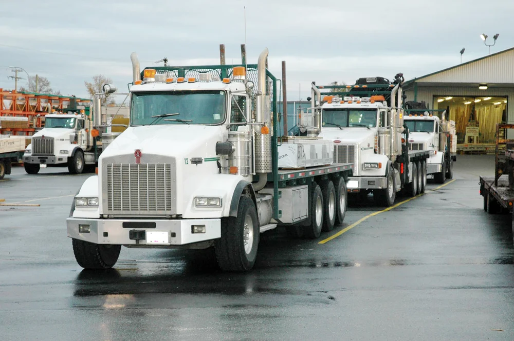 Country Lumber delivery trucks loaded and lined up at the Langley yard