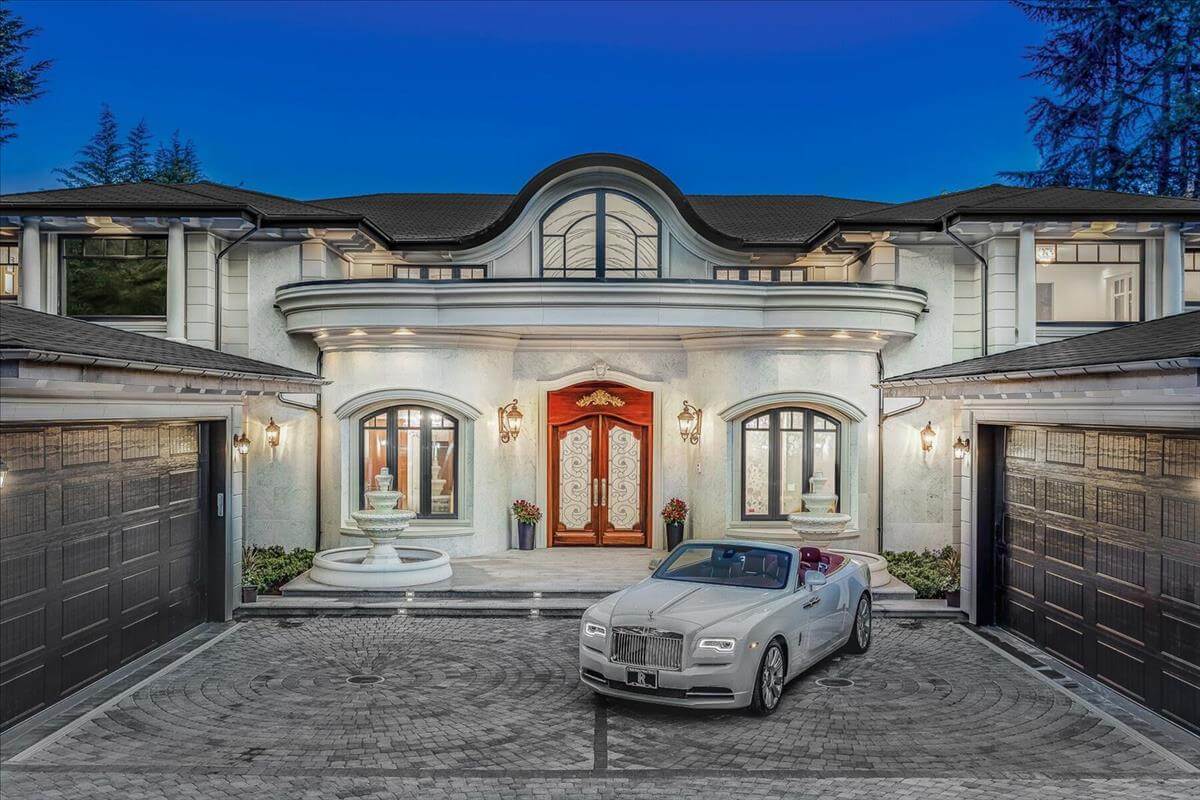A high-end custom home with architectural columns, cornices and window surrounds